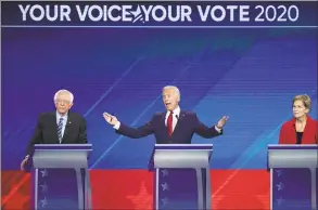  ?? David J. Phillip / Associated Press ?? Sen. Bernie Sanders, IVt., left, and Sen. Elizabeth Warren, DMass., right, listen as former Vice President Joe Biden, center, speaks Thursday during a Democratic presidenti­al primary debate hosted by ABC at Texas Southern University in Houston.