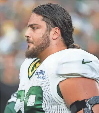  ?? JIM MATTHEWS / USA TODAY NETWORK ?? David Bakhtiari leaves the field after suffering an ankle injury Saturday. His teammates hope it is not serious.