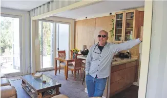  ??  ?? Rick Clegg shows off the open-concept living room, dining room, kitchen in his 1,200-square-foot shipping-container house.