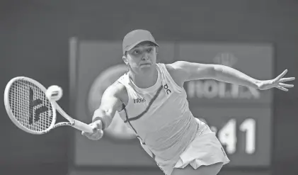  ?? ?? Iga Swiatek returns to Maria Sakkari during the women’s singles final at the BNP Paribas Open in Indian Wells, Calif., on March 17.