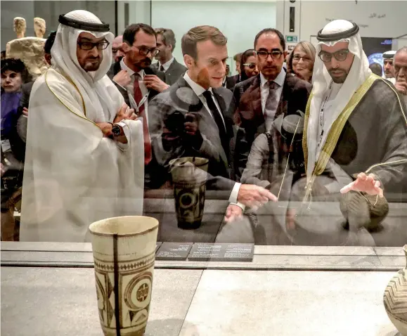  ?? ?? His Highness Sheikh Mohamed bin Zayed Al Nahyan, French President Emmanuel Macron, Chairman of Abu Dhabi’s Tourism and Culture Authority Mohamed Khalifa Al Mubar Abu Dhabi Museum on November 8, 2017, during its inaugurati­on on Saadiyat island