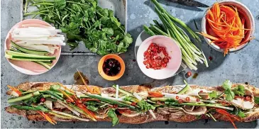  ??  ?? Adam Liaw’s mega banh mi is drizzled with seasoning before serving.