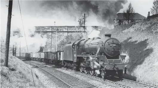  ?? Author ?? Heading south with ‘empties’ from Granton, LMS Stanier ‘5MT’ 4-6-0 No 45023 passes the distant signal for Murrayfiel­d at Ravelston Dykes road bridge when passing with a Granton to Slateford freight, the target number ‘E8’ being carried on the locomotive’s lower-right lamp bracket. Generally, although patterns of operation existed, freight movements were planned out on a week-by-week basis, with target numbers identifyin­g the duties. New to Perth shed on 20 August 1934, the pictured engine is in its second spell at Dalry Road, from 29 September 1951 through to its withdrawal on 16 September 1963. The large version of the early BR crest and no AWS, fitted on 28 August 1959, help to date the view.