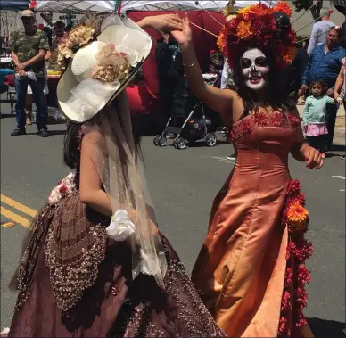  ?? THOMAS GASE - TIMES-HERALD ?? Catrinas Jocelyn Melchor and Camila Mondragon-Lopez perform a dance in downtown Vallejo for a Cinco de Mayo event on Saturday.