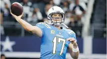  ?? MICHAEL AINSWORTH/THE ASSOCIATED PRESS ?? Los Angeles Chargers pivot Philip Rivers throws a warm-up pass Thursday in Arlington, Texas.