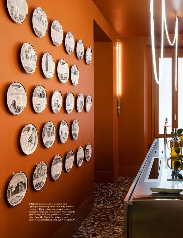  ??  ?? Kitchen Luciano’s custom-designed neon lighting snakes through from the dining area into this space. The architect also created the steel cabinetry, which is lit from inside to create a gentle glow through the fluted glass doors. Fornasetti plates (from the ‘Ricette’ series) on the wall connect this home to an Italian legacy of luxury