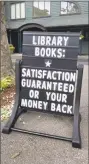  ?? File photo ?? A tongue-in-cheek message is displayed on a sandwich board outside the East Hampton Public Library.