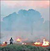  ?? AFP ?? A farmer burns stubble after harvesting soyabean crop in his field on the outskirts of Bhopal.