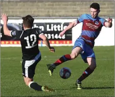  ??  ?? Mark Hughes controls the ball under pressure from Niall McGinley.