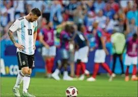  ?? PRESS THANASSIS STAVRAKIS/ASSOCIATED ?? Argentina’s Lionel Messi reacts as France players celebrate taking the lead with their side’s third goal by France’s Kylian Mbappe, during the round of 16 match between France and Argentina, Saturday at the Kazan Arena in Kazan, Russia.