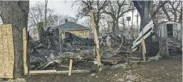  ?? CAROLE CARLSON/POST-TRIBUNE ?? The charred remains of a New Chicago house at 29th and Decatur Streets are visible Thursday — a day after a blaze erupted that killed an unidentifi­ed woman. Fire officials are investigat­ing the cause of the fire.
