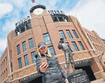  ?? Hyoung Chang, The Denver Post ?? Rockies fan Beth Riley of Denver takes a selfie outside an empty Coors Field on Friday. The Rockies’ home opener against the Padres was canceled because of the coronaviru­s pandemic.