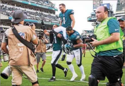  ?? RICK KAUFFMAN — DIGITAL FIRST MEDIA ?? Eagles kicker Jake Elliot (11) is carried off the field by Mychal after hitting a game-winning 61-yard field goal. Kendricks, right, and Kamu Grugier-Hill, left,
