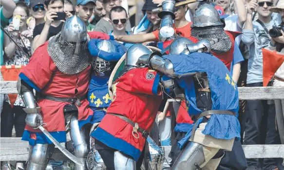  ?? Picture: AP ?? French (in blue) and British fighters take part in combat during the four-day world championsh­ip of medieval combat near Kiev.