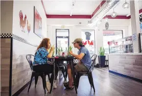  ?? ?? Bella Romero and Aristeo Ballejos enjoy wings at Wing It Up located in Downtown Albuquerqu­e.