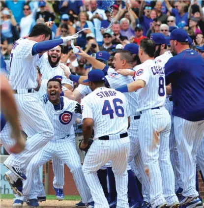  ?? | GETTY IMAGES ?? Kris Bryant (left, after hitting awalk-off home run) is part of an impressive rookie contingent with the Cubs.