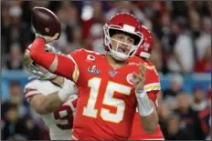  ?? The Associated Press ?? MAHOMES MADE A DEAL: Kansas City Chiefs quarterbac­k Patrick Mahomes (15) passes against the San Francisco 49ers during the first half of Super Bowl 54 on Feb. 2 in Miami Gardens, Fla. The Chiefs have agreed to a 10-year contract extension with Super Bowl MVP Mahomes keeping him around through 2031. The Chiefs had Mahomes under contract for the next two seasons but wanted a long-term deal in place with the quarterbac­k who led them to their first championsh­ip in 50 years. ESPN.com reported the deal is worth $450 million with an injury guarantee of $140 million.