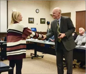  ?? CHAD FELTON — THE NEWS-HERALD ?? Sara Spence shakes hands with attorney Mark Landes of Isaac Wiles Law Firm after being sworn in as a member of the Laketran Board of Trustees. Spence, appointed to the board last month by the Lake County commission­ers, is the president of Willoughby-based Spence Technologi­es, Inc.