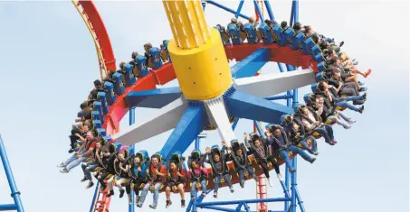  ?? GREG GRUDT/MATHEW IMAGING ?? Above: Wonder Woman Lasso of Truth, a thrilling swing pendulum ride, opened this year at Six Flags Discovery Kingdom in Vallejo. Below: Walkers are seen along the Bay Area Ridge Trail at Glen Cove Waterfront Park in Vallejo.