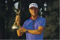  ?? JOHN RAOUX — THE ASSOCIATED PRESS ?? Justin Thomas holds the trophy after winning The Players Championsh­ip golf tournament on Sunday in Ponte Vedra Beach, Fla.