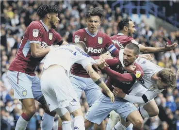  ??  ?? This melee involving Leeds and Aston Villa players followed the home side’s controvers­ial goal.