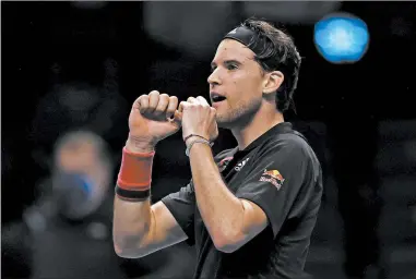  ?? CLIVE BRUNSKILL/GETTY ?? Dominic Thiem celebrates winning match point during his semifinal match on Saturday.