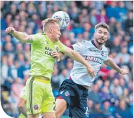  ??  ?? Mark Duffy and Luke Murphy battle for the ball