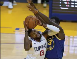  ?? TONY AVELAR — THE ASSOCIATED PRESS ?? Los Angeles Clippers guard Paul George (13) reacts as he is fouled by Warriors forward Draymond Green during the first half on Friday.