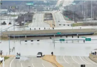  ??  ?? Water fromtheMer­amec River cuts off Interstate 44 and Missouri 141 in southwest St. Louis County onWednesda­y. J. B. Forbes, St. Louis Post- Dispatch