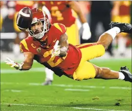  ?? Sean M. Haffey Getty Images ?? ISAIAH POLA-MAO intercepts a pass for USC. The safety was not immune from defensive struggles early against UCLA but USC got better after halftime.