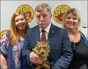  ?? COURTESY OF RICHARD FIKE SR. ?? Richard Fike Sr., director of Stunt Predators USA & SFX, is joined by his daughters, Sara Lashley, left, and Leah Turner, at the group’s first-ever Stunt Awards Banquet in Madison Village on Jan. 18. Fike is holding a special award he received from Stunt Predators honoring him for his leadership of the profession­al stunt organizati­on.