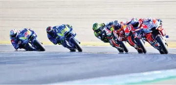  ??  ?? (From L) Team Suzuki Ecstar Spanish rider Alex Rins, Team Suzuki Ecstar Italian rider Andrea Iannone, LCR Honda British rider Cal Crutchlow, Repsol Honda Team Spanish rider Marc Marquez and Ducati Team Italian rider Andrea Dovizioso compete during the MotoGP Japanese Grand Prix at Twin Ring Motegi circuit in Motegi,Tochigi prefecture on October 21, 2018. - Honda’s Marc Marquez stormed to victory in a nail-biting Japan race on October 21 to capture his third straight MotoGP world title. — AFP