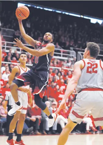  ?? Tony Avelar / Associated Press ?? Arizona guard Parker Jackson-Cartwright takes the ball to the basket against Reid Travis.