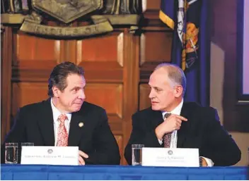  ?? MIKE GROLL AP ?? New York Gov. Andrew Cuomo (left) and then-Secretary to the Governor Larry Schwartz, who is now leader of state vaccinatio­n efforts, are seen during a cabinet meeting Dec. 17, 2014, in Albany, N.Y.