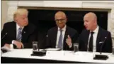  ?? ALEX BRANDON — THE ASSOCIATED PRESS FILE ?? President Donald Trump, left, and Satya Nadella, Chief Executive Officer of Microsoft, center, listen as Jeff Bezos, Chief Executive Officer of Amazon, speaks during an American Technology Council roundtable in the State Dinning Room of the White House in Washington.