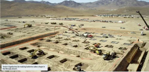  ??  ?? Tesla’s Gigafactor­y for making batteries takes shape in the Nevada desert.