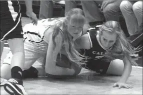  ?? SIERRA CAMPBELL / staff ?? Calhoun's Jana Johns (right) and Woodland's Hayley Roberson battle for a loose ball during Wednesday's Rome News-Tribune Holiday Festival game.