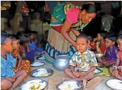  ??  ?? Children are being served hot meal at Satyagaon Anganwadi centre in Odisha.