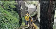  ?? [MICHAEL SHORT/THE ASSOCIATED PRESS] ?? Southern Marin Fire Department members search a crushed house in the aftermath of a mudslide that destroyed three homes on a hillside Thursday in Sausalito, Calif.