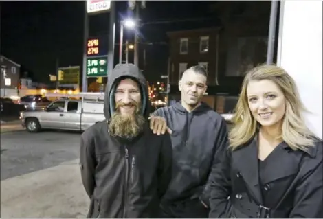  ?? ELIZABETH ROBERTSON — THE PHILADELPH­IA INQUIRER VIA AP, FILE ?? In this photo, Johnny Bobbitt Jr., left, Kate McClure, right, and McClure’s boyfriend Mark D’Amico pose at a Citgo station in Philadelph­ia.
people who helped him in the last few years during this rough patch in his life, she said.
And that dream...