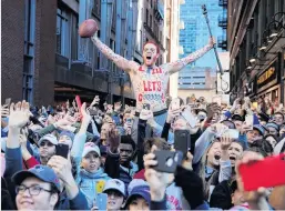  ?? PHOTO: REUTERS ?? Jubilation . . . Fans cheer during a victory parade for the New England Patriots after winning the Super Bowl in Boston, Massachuse­tts.