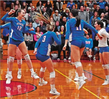  ?? SEAN D. ELLIOT/THE DAY ?? Waterford players celebrate match point against Haddam-Killingwor­th iduring Tuesday night’s CIAC Class M volleyball tournament semifinal match at Fitch HIgh School. The 11th-seeded Lancers swept the No. 15 Cougar and will play top-seeded and defending champion Seymour in Saturday’s 1 p.m. final at East Haven High School. Visit www.theday.com to view a photo gallery.