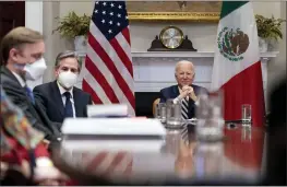  ?? ANDREW HARNIK — THE ASSOCIATED PRESS ?? President Joe Biden, accompanie­d by White House national security adviser Jake Sullivan, left, and Secretary of State Antony Blinken attends a virtual meeting with Mexican President Andres Manuel Lopez Obrador, in the Roosevelt Room of the White House on Monday.