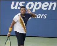  ?? SETH WENIG — THE ASSOCIATED PRESS ?? Nick Kyrgios, of Australia, reacts against Pierre-Hugues Herbert, of France, during the second round of the U.S. Open tennis tournament, Thursday in New York.