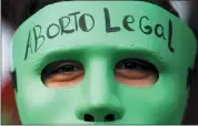  ?? ASSOCIATED PRESS FILE PHOTO ?? An abortion-rights activist wears a mask with text that reads in Spanish “Legal Abortion” during a rally outside Congress as lawmakers debate a bill that would legalize abortion, in Buenos Aires, Argentina, in 2020.