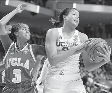  ?? Jessica Hill Associated Press ?? CONNECTICU­T’S Napheesa Collier pulls down a defensive rebound against UCLA’s Jordin Canada during the first half of a regional semifinal of the NCAA women’s tournament. UConn won, 86-71.