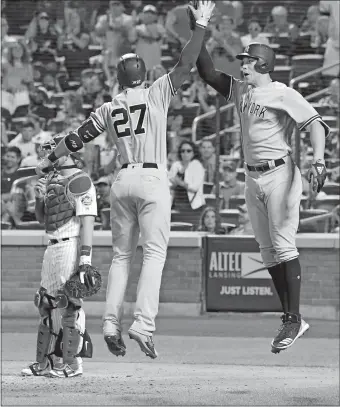  ?? BILL KOSTROUN/AP PHOTO ?? The Yankees’ Aaron Judge, right, celebrates his go-ahead home run with teammate Giancarlo Stanton on Saturday night during the eighth inning against the Mets at Citi Field in New York. The Yankees won, 4-3.