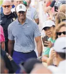  ?? NAH Y. HUH/ASSOCIATED PRESS ?? Tiger Woods smiles while greeting fans during Wednesday’s pro-am round at the BMW Championsh­ip in Medinah, Ill.