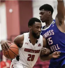  ?? AP ?? NO MORE MAGIC: Hartford’s Austin Williams pushes his way to the basket past UMass Lowell’s Allin Blunt during the America East Conference championsh­ip game on Saturday in Hartford, Conn.