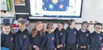  ?? ?? Our junior room playing games on the smart board and learning about the Solar System.